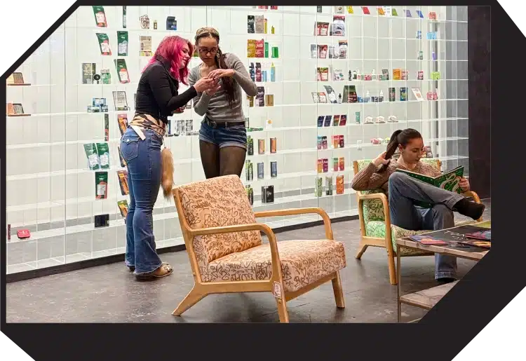 Customers relaxing inside RNR Dispensary near cannabis product displays